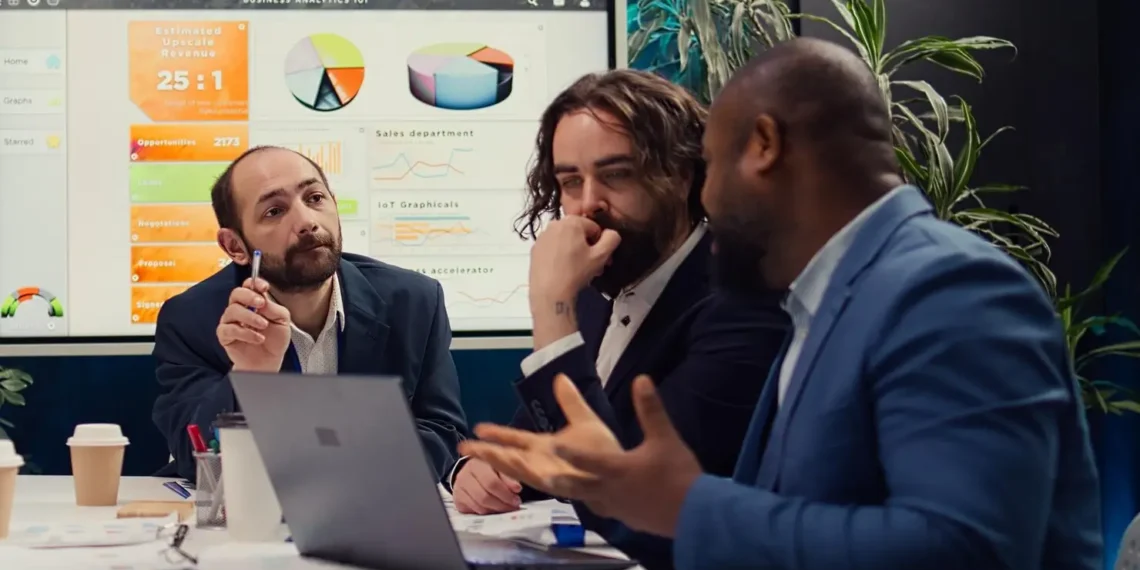 Corporate workers looking into project updates and timelines in boardroom