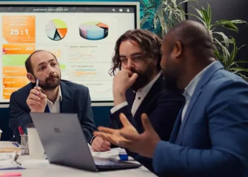 Corporate workers looking into project updates and timelines in boardroom