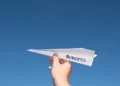 Hand holding a paper plane