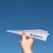 Hand holding a paper plane