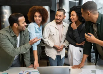 Diverse team members collaborating in a modern office setting, showcasing open communication and mutual respect.